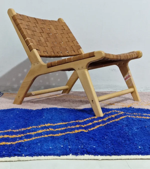 Handwoven Moroccan rug with a jagged blue and beige design and yellow zigzag lines in room