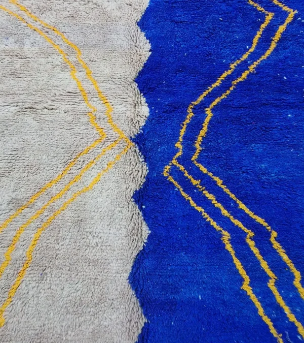 Detailed View of Handwoven Moroccan rug with a jagged blue and beige design and yellow zigzag lines