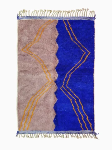 Top View of Handwoven Moroccan rug with a jagged blue and beige design and yellow zigzag lines