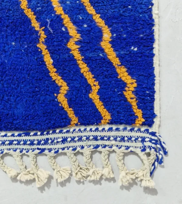 Detailed View of Handwoven Moroccan rug with a jagged blue and beige design and yellow zigzag lines