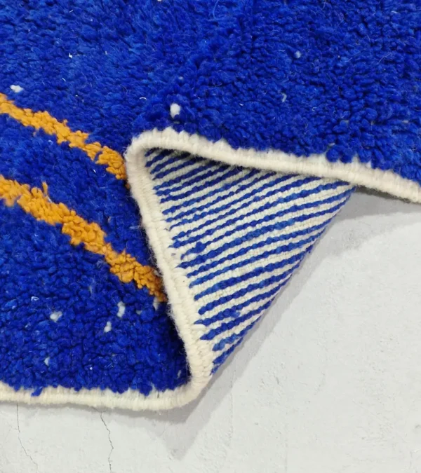 Detailed View of Handwoven Moroccan rug with a jagged blue and beige design and yellow zigzag lines