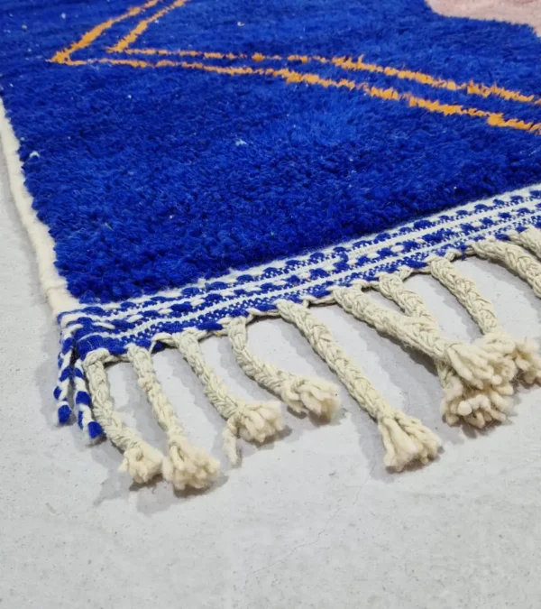 Detailed View of Handwoven Moroccan rug with a jagged blue and beige design and yellow zigzag lines