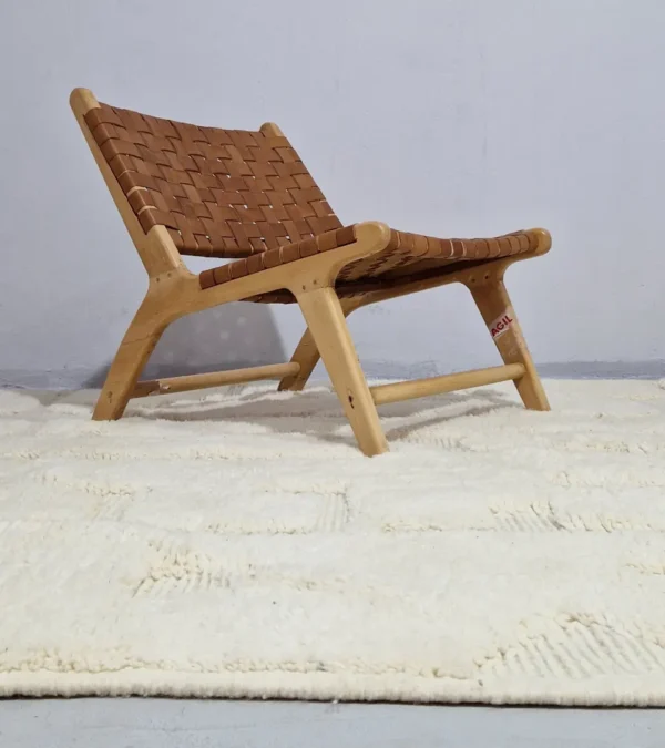 handmade Moroccan wool rug with a subtle geometric design created by varying pile heights in neutral tones in room