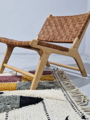 Imani handmade Beni Ourain wool rug with a boho geometric high-low design in multicolor hues including plum, yellow, black, and gray in room
