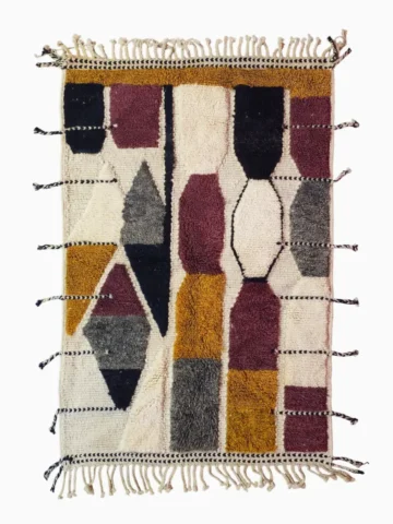 Top View of Imani handmade Beni Ourain wool rug with a boho geometric high-low design in multicolor hues including plum, yellow, black, and gray