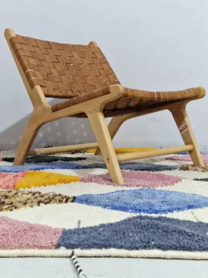 Iris handmade Moroccan wool rug with a colorful diamond design in yellow, pink, blue, black, and ivory in room