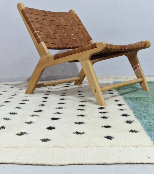 Johana handmade Moroccan wool rug with a modern dotted pattern and two-tone green and ivory design in room