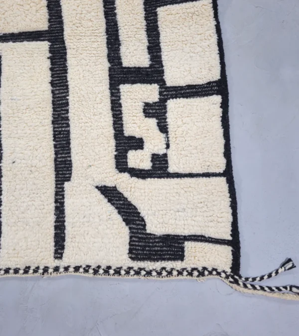Detailed View of Handmade Moroccan Beni Ourain wool rug with abstract striped pattern in ivory and black