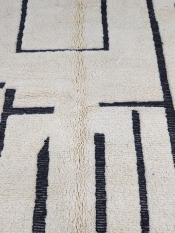Detailed View of Handmade Moroccan Beni Ourain wool rug with abstract striped pattern in ivory and black