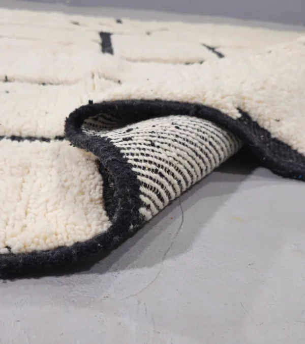 Detailed View of Handmade Moroccan Beni Ourain wool rug with abstract striped pattern in ivory and black