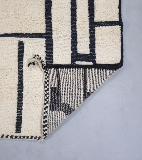 Detailed View of Handmade Moroccan Beni Ourain wool rug with abstract striped pattern in ivory and black