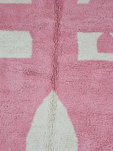 Detailed View of Juju handmade Moroccan wool rug with a contemporary geometric pattern in pink and ivory
