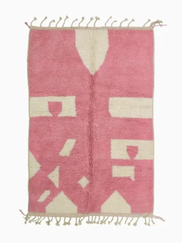 Top View of Juju handmade Moroccan wool rug with a contemporary geometric pattern in pink and ivory