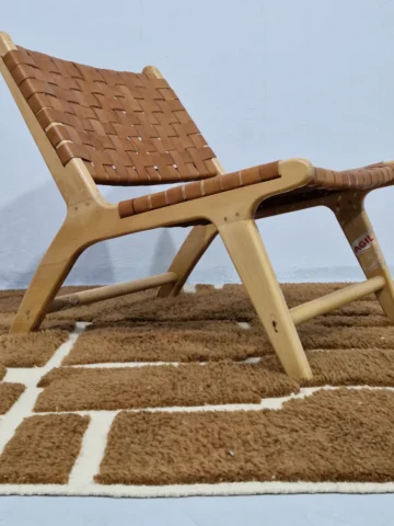 Handmade Moroccan wool rug with an abstract maze-like design in brown and off-white in room
