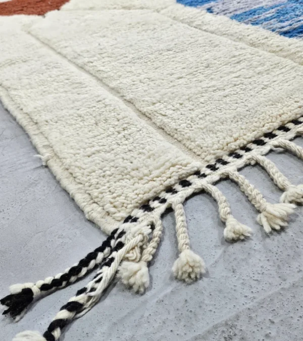 Detailed View of Kaia handmade Moroccan wool rug with a vibrant abstract design and a textured high/low pile