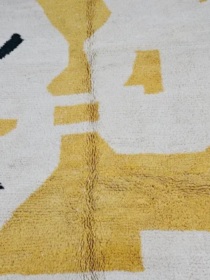 Detailed View of Kami handmade Beni Ourain wool rug with a contemporary abstract design in yellow, black, and pink