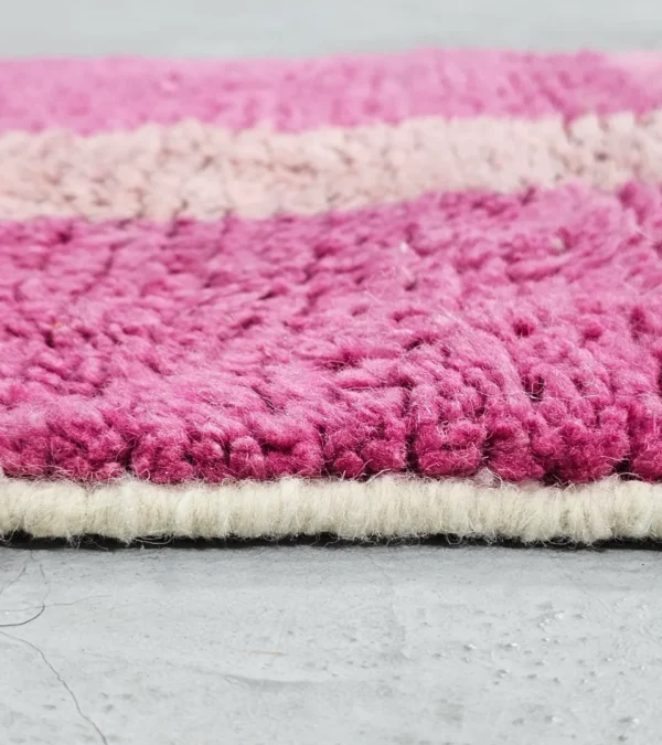 Zoomed In View of Kami handmade Beni Ourain wool runner with a pink abstract design in fuchsia and ivory