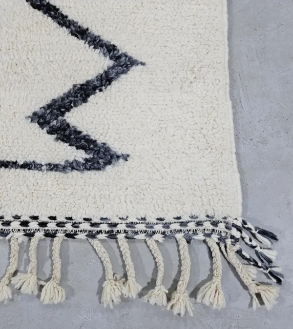 Detailed View of Kita handmade Beni Ourain wool rug with a minimalist abstract design in brown, black, and ivory