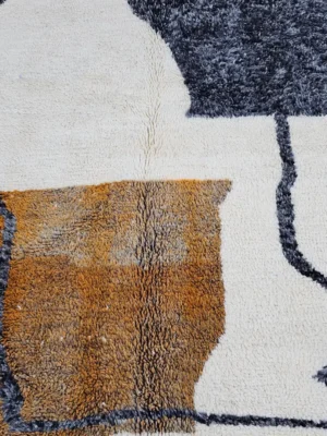 Detailed View of Kita handmade Beni Ourain wool rug with a minimalist abstract design in brown, black, and ivory