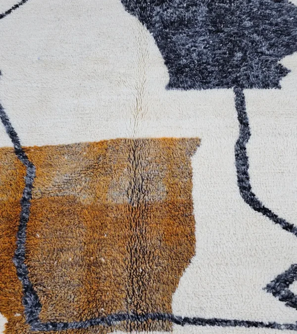 Detailed View of Kita handmade Beni Ourain wool rug with a minimalist abstract design in brown, black, and ivory