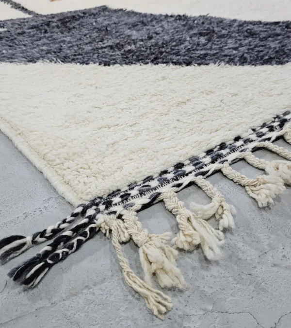 Detailed View of Kita handmade Beni Ourain wool rug with a minimalist abstract design in brown, black, and ivory