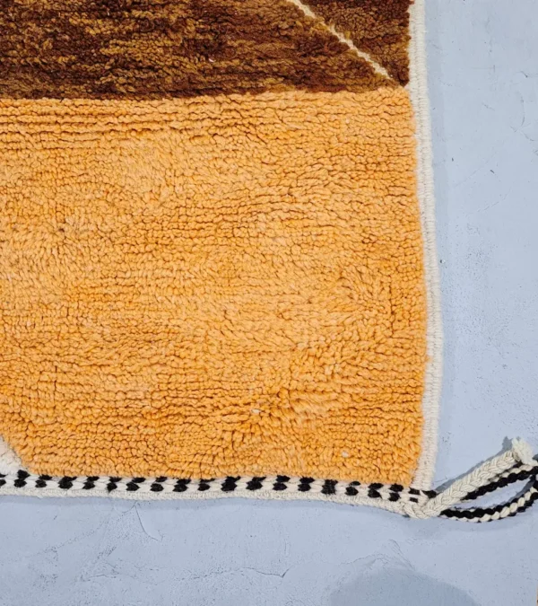 Detailed View of Leila handmade Beni Mrirt wool rug with a contemporary abstract patchwork design in multicolor, including brown, blue, yellow, and gray