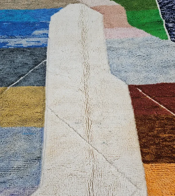 Detailed View of Leila handmade Beni Mrirt wool rug with a contemporary abstract patchwork design in multicolor, including brown, blue, yellow, and gray