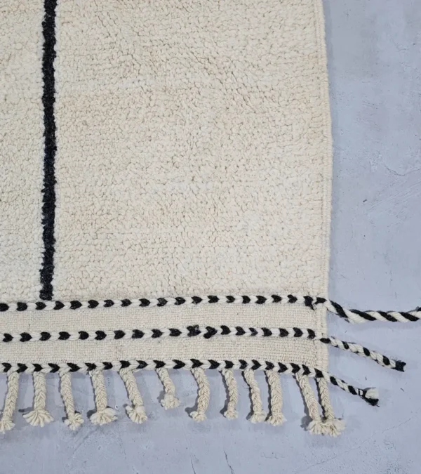 Detailed View of Lina handmade Beni Ourain wool rug with a geometric lined design in black, ivory, blue, pink, orange, and teal