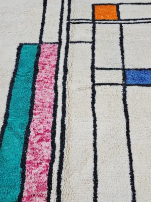 Detailed View of Lina handmade Beni Ourain wool rug with a geometric lined design in black, ivory, blue, pink, orange, and teal
