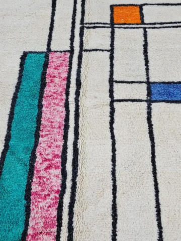 Detailed View of Lina handmade Beni Ourain wool rug with a geometric lined design in black, ivory, blue, pink, orange, and teal