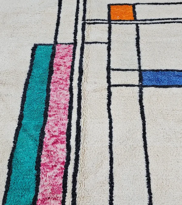 Detailed View of Lina handmade Beni Ourain wool rug with a geometric lined design in black, ivory, blue, pink, orange, and teal