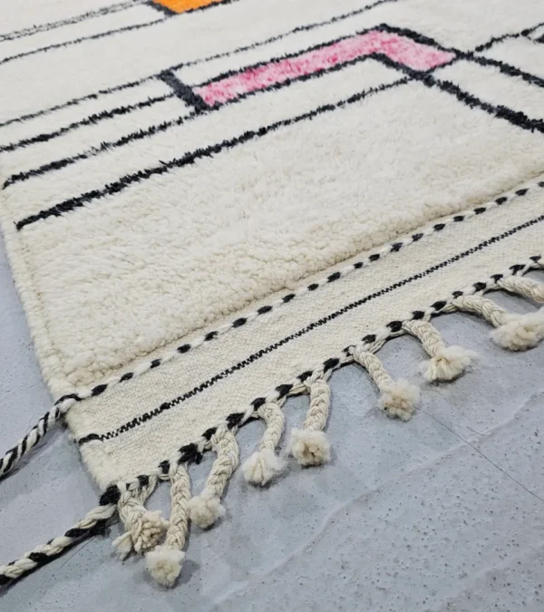 Detailed View of Lina handmade Beni Ourain wool rug with a geometric lined design in black, ivory, blue, pink, orange, and teal