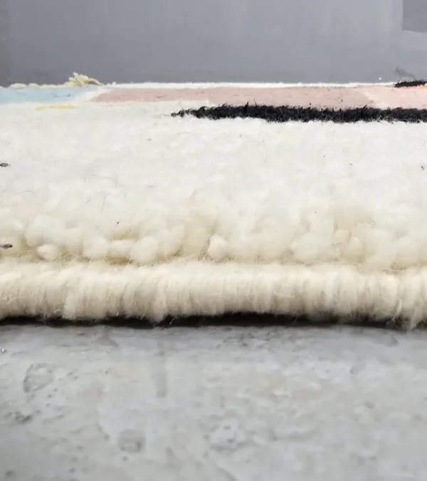 Zoomed In View of Handmade Moroccan wool rug with abstract multicolor geometric shapes