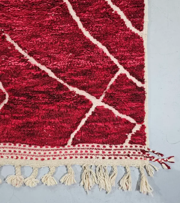 Detailed View of Lina handmade Beni Mrirt wool rug with an abstract lined design in red and ivory
