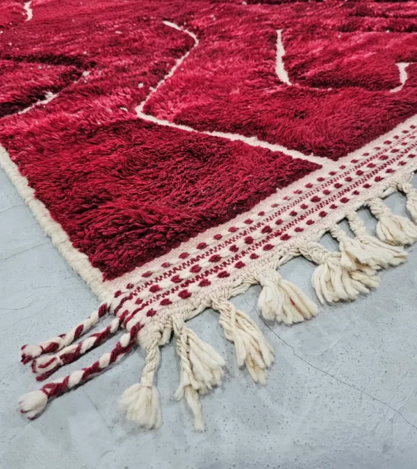 Detailed View of Lina handmade Beni Mrirt wool rug with an abstract lined design in red and ivory
