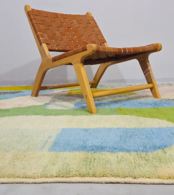 Liora handmade Beni Ourain wool rug with a vibrant abstract design in green, blue, yellow, and pink in room