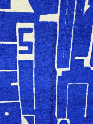 Detailed View of Lora handmade Moroccan wool rug with an abstract striped blue and ivory design and high/low pile