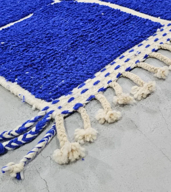 Detailed View of Lora handmade Moroccan wool rug with an abstract striped blue and ivory design and high/low pile