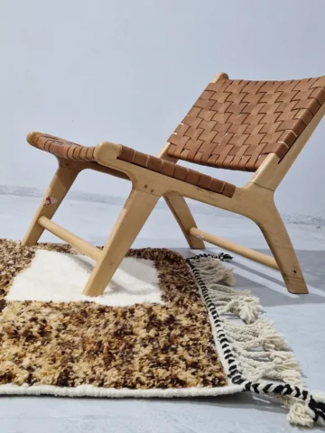 Luna handmade Beni Ourain wool rug with a boho brown background and a geometric pattern in ivory and blue in room