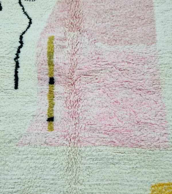 Detailed View of Handmade Moroccan wool rug with an abstract colorblock design in pink, yellow, and black
