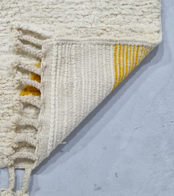 Detailed View of Handmade Moroccan wool rug with an abstract colorblock design in pink, yellow, and black