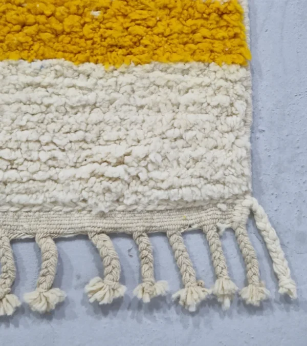 Detailed View of Handmade Moroccan wool rug with an abstract colorblock design in pink, yellow, and black