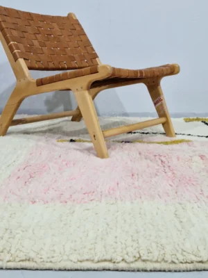Handmade Moroccan wool rug with an abstract colorblock design in pink, yellow, and black in room