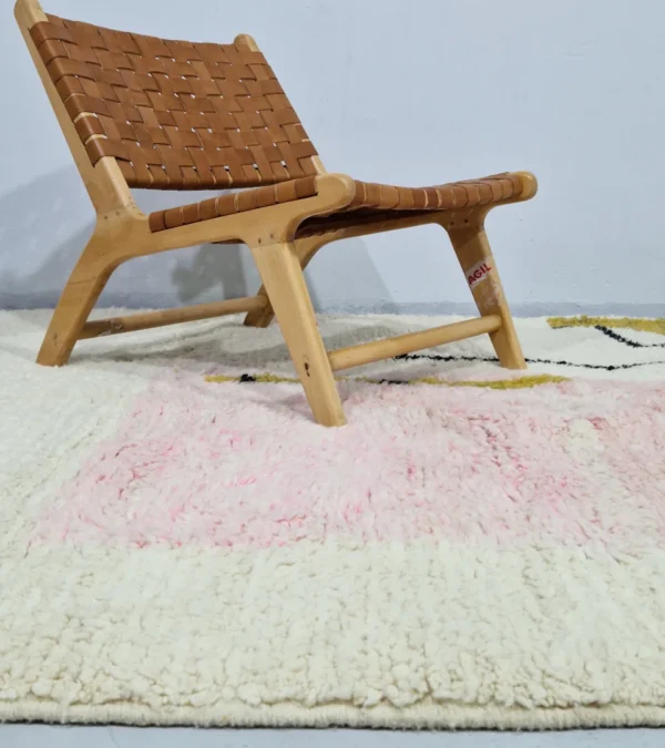 Handmade Moroccan wool rug with an abstract colorblock design in pink, yellow, and black in room