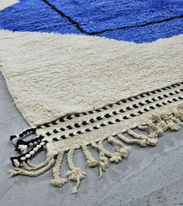 Detailed View of Handmade Moroccan wool rug with blue and mustard abstract design and black outline