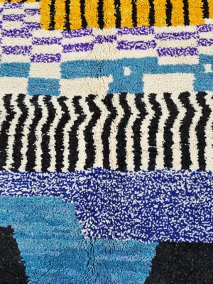 Detailed View of Nareen handmade Beni Mrirt wool rug with a contemporary bohemian abstract geometric design in blue, yellow, and black