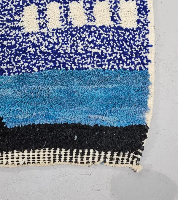 Detailed View of Nareen handmade Beni Mrirt wool rug with a contemporary bohemian abstract geometric design in blue, yellow, and black