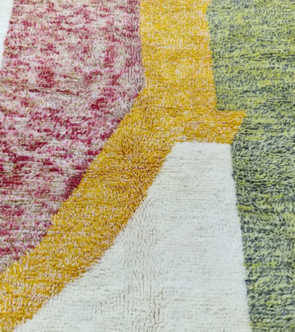 Detailed View of Naya handmade Azilal wool rug with a contemporary color blocks design in yellow, green, pink, brown, and ivory