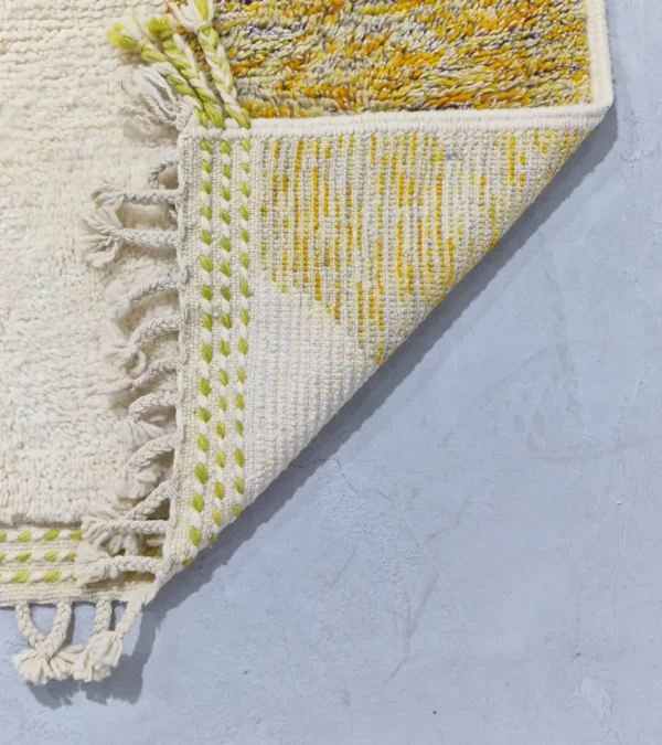 Detailed View of Naya handmade Azilal wool rug with a contemporary color blocks design in yellow, green, pink, brown, and ivory