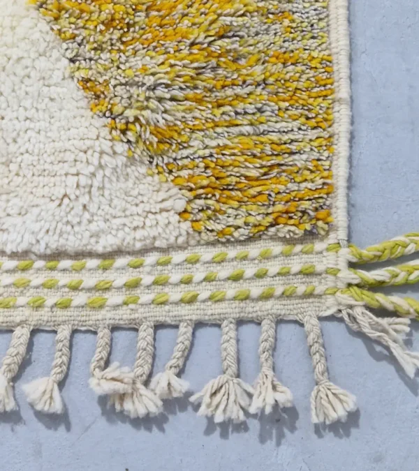 Detailed View of Naya handmade Azilal wool rug with a contemporary color blocks design in yellow, green, pink, brown, and ivory